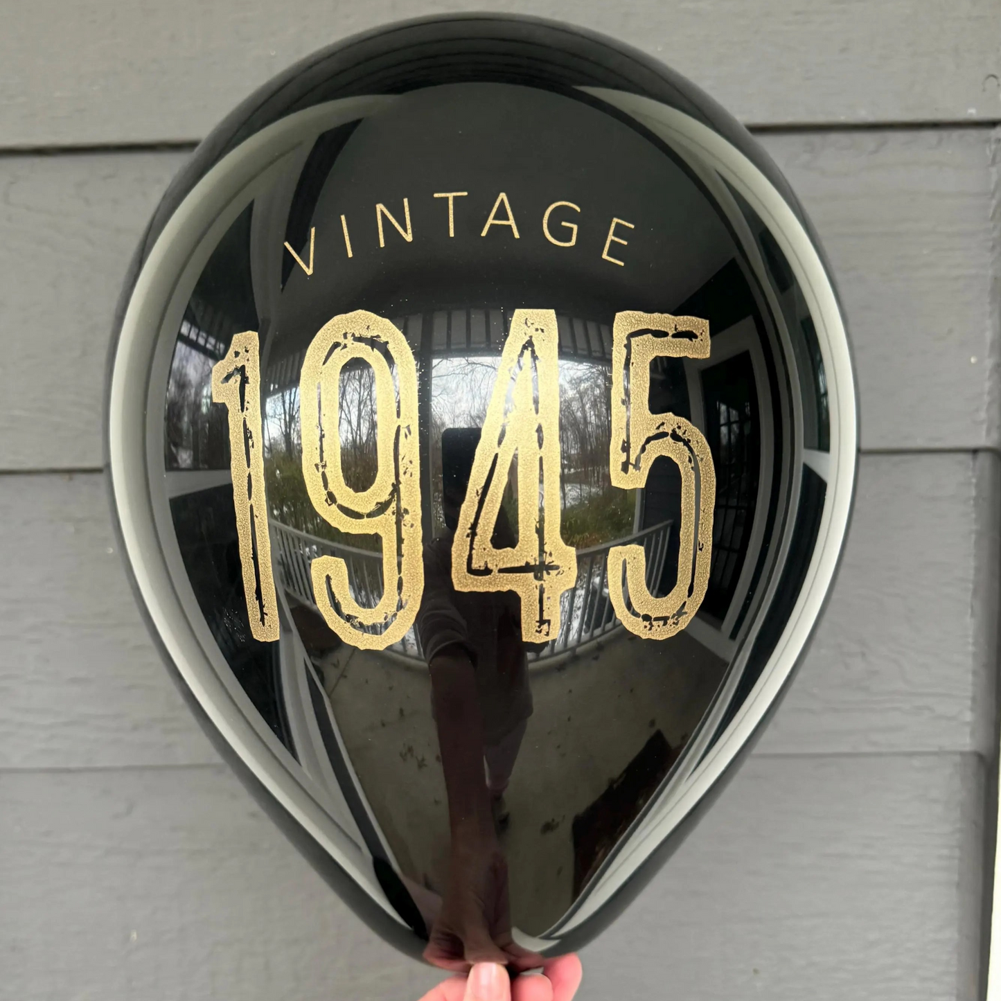 12 inch black latex balloon that reads Vintage 1945 in gold metallic ink.
80th Birthday Balloons