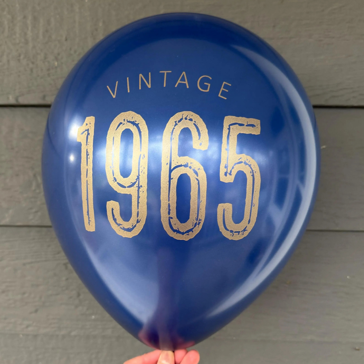12 inch navy latex balloon that reads Vintage 1965 in gold metallic font.
60th birthday decorations