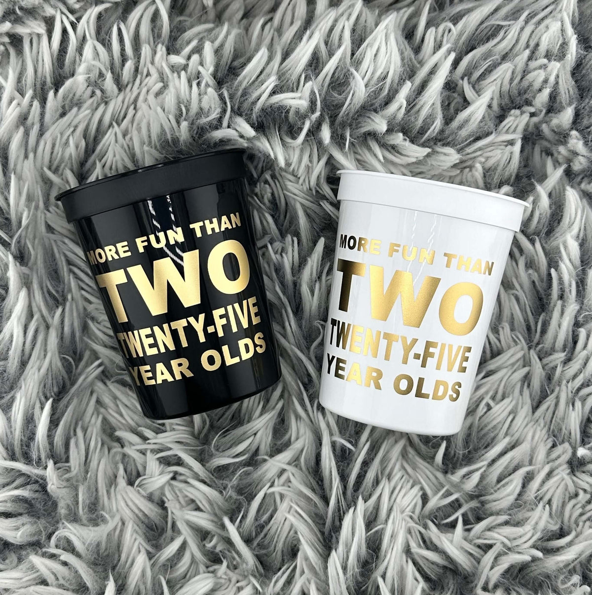 More Fun Than Two Twenty-Five Year Olds cups black and white with gold text