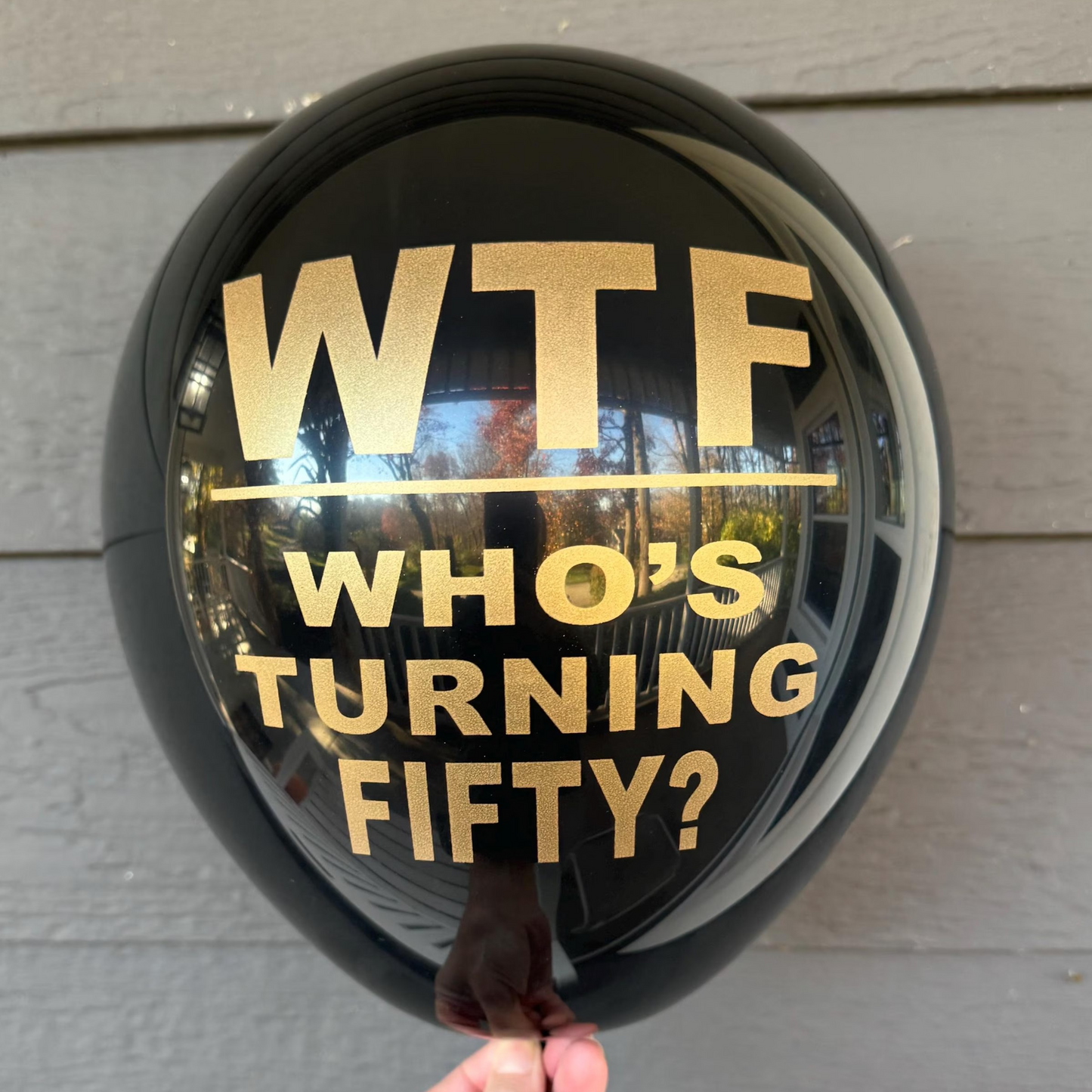 12 inch black balloons that read WTF Who's Turning Fifty? in gold metallic font. 50th Birthday Balloons