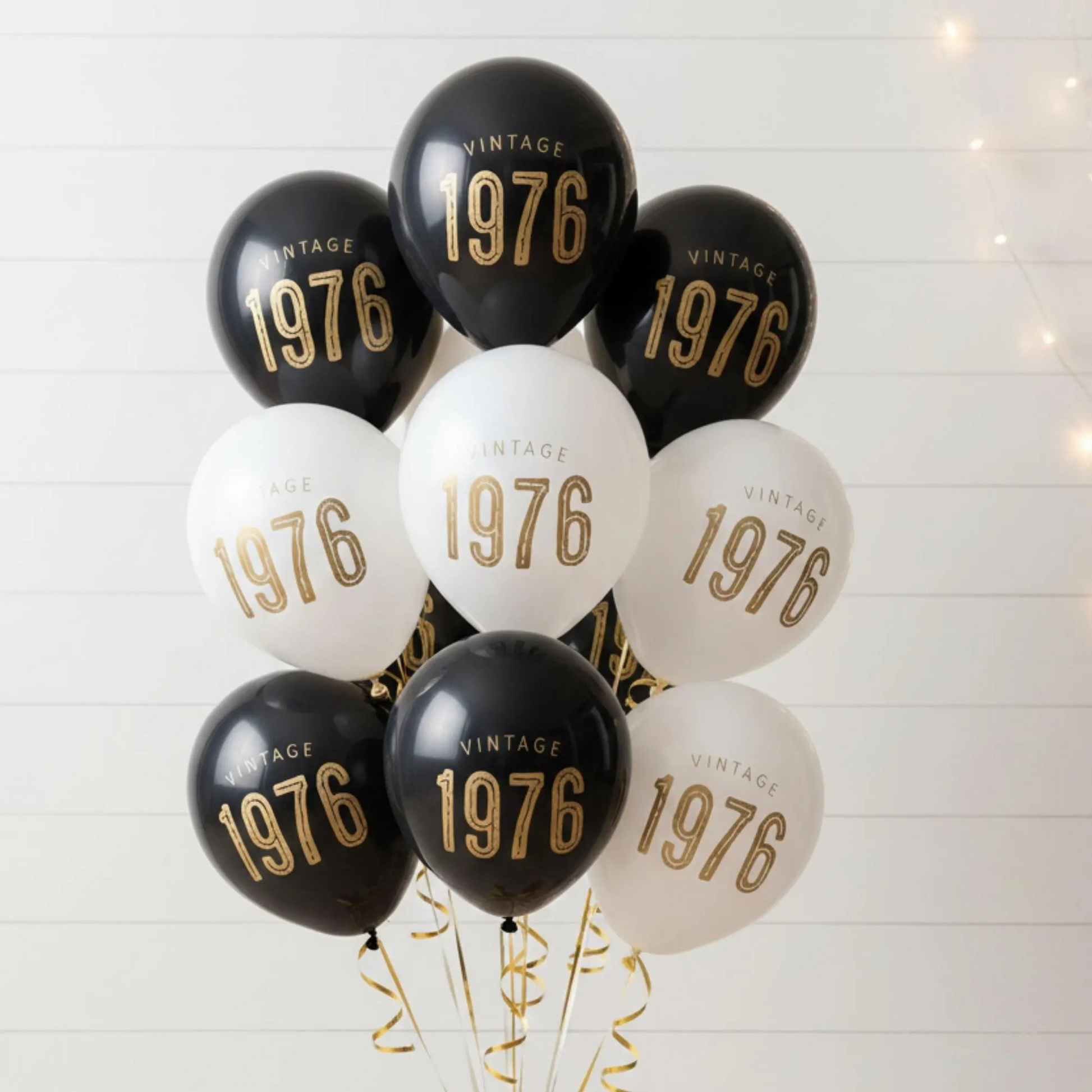 50th Birthday balloons.  A balloon bouquet of black and white balloons that read Vintage 1976 in bold font.  Perfect 50th Birthday Decor for a milestone celebration