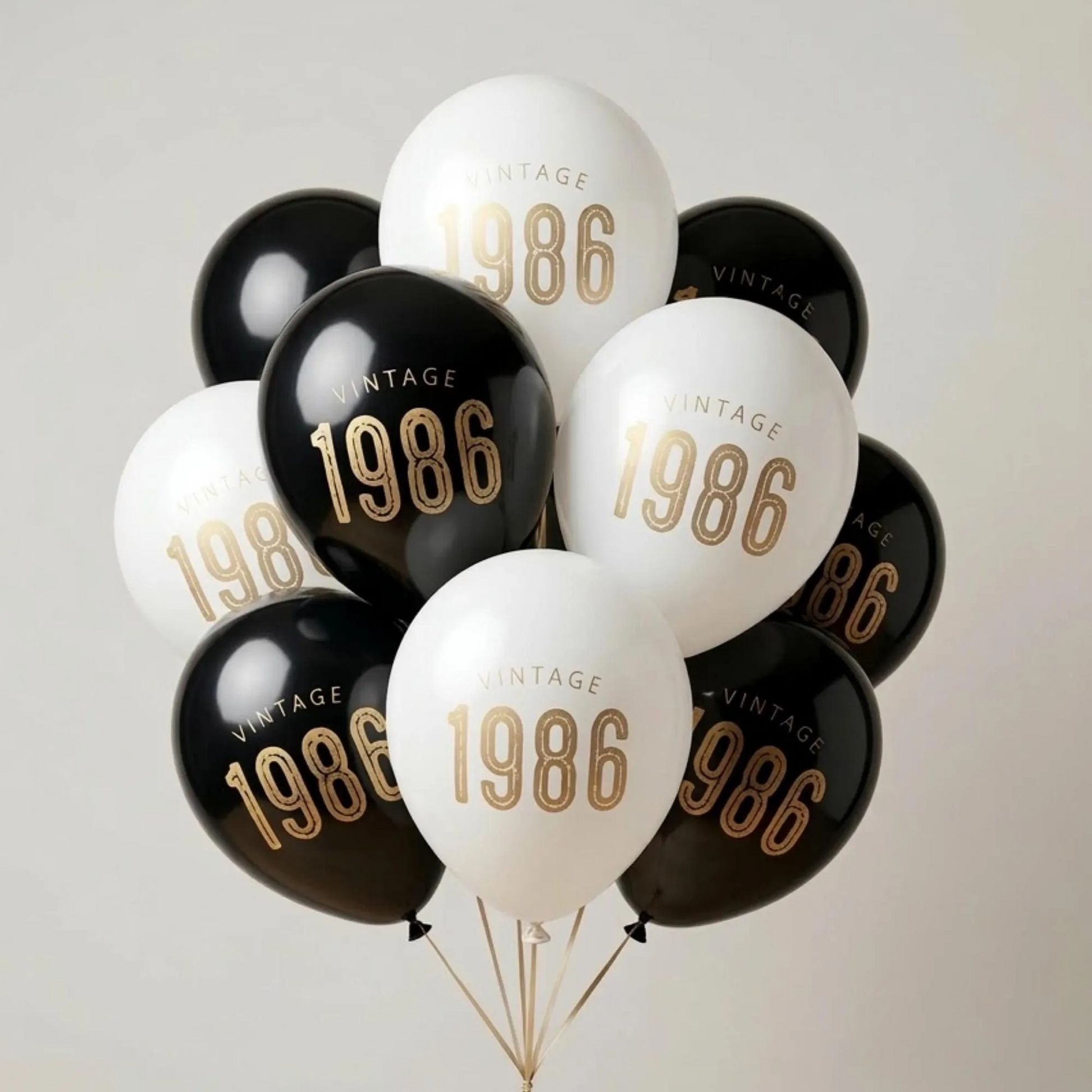 40th Birthday balloons.  A balloon bouquet of black and white balloons that read Vintage 1986 in bold gold font.  Perfect 40th Birthday Decor for a milestone celebration