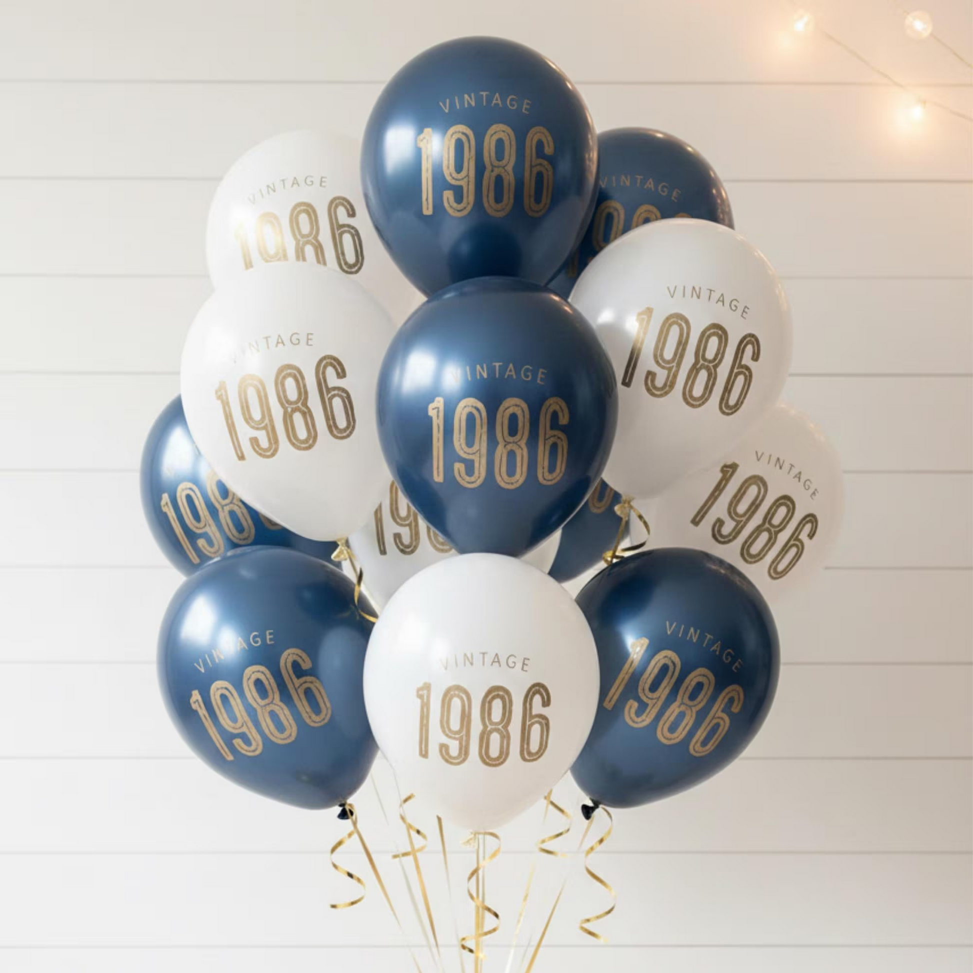 40th Birthday balloons.  A balloon bouquet of navy and white balloons that read Vintage 1986 in bold gold font.  Perfect 40th Birthday Decorations for a milestone celebration