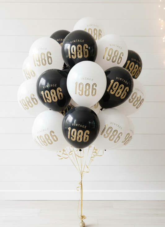 Bouquet of balloons with '1986' printed on them against a white background