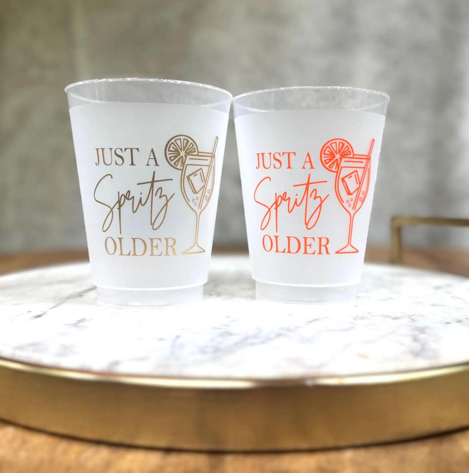 16 ounce frosted cup that reads Just a spritz older with an aperol sprits image.  The cups come in gold metallic ink or orange ink, for any age Birthday