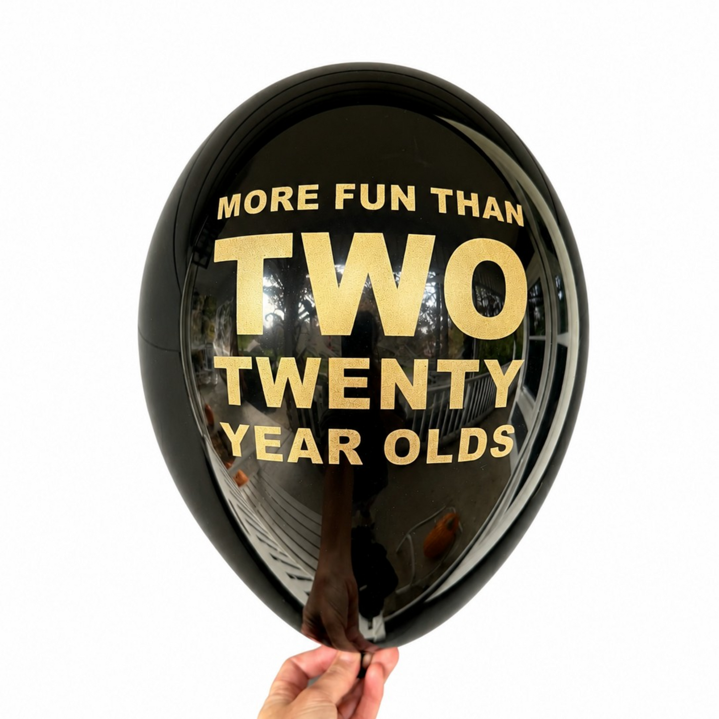 40th Birthday Balloon.  The balloon is black and read more fun than two twenty year olds in gold text.  Funny 40th Birthday Decorations