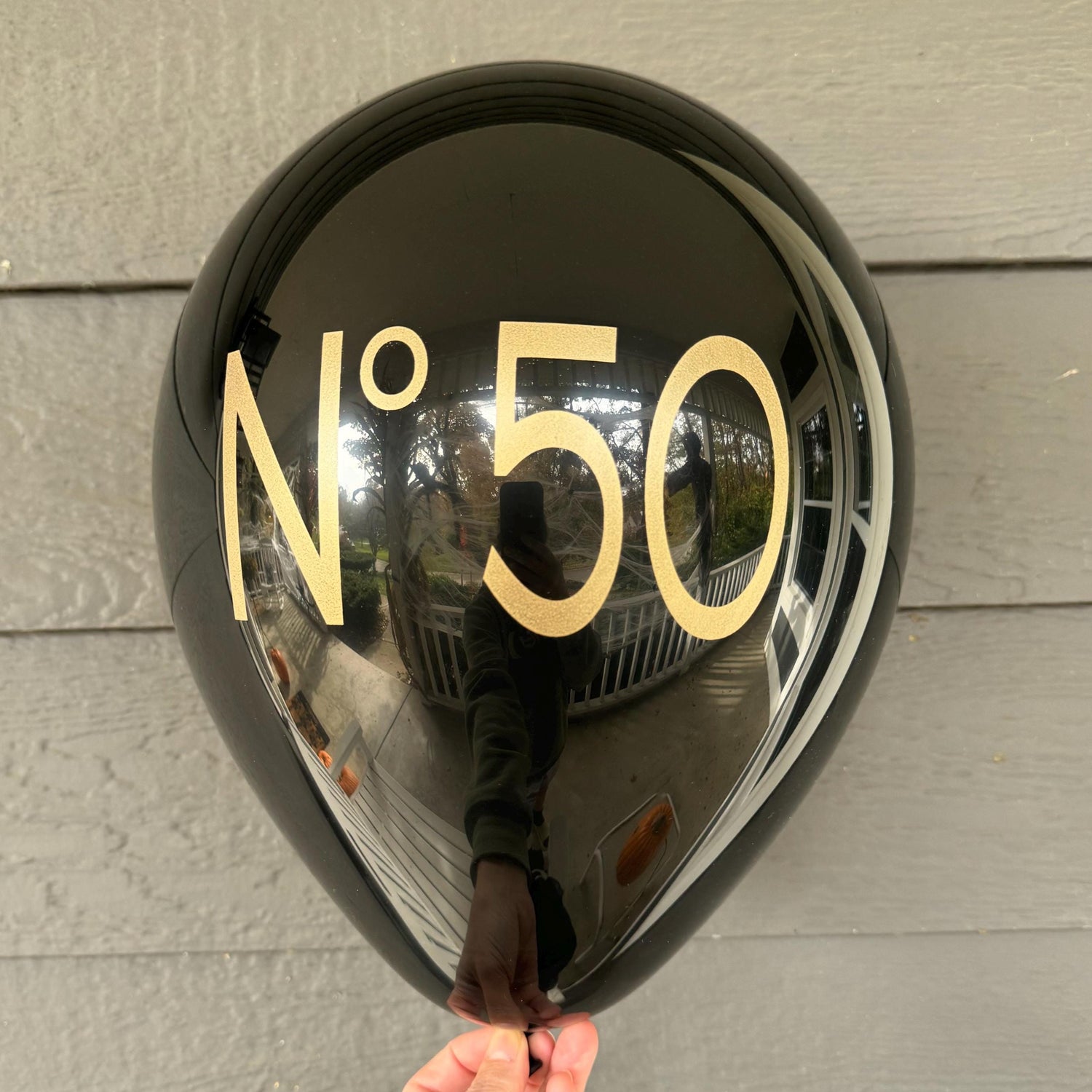 12 inch black latex balloons that read No 50 in a gold metallic font.  50th birthday balloons