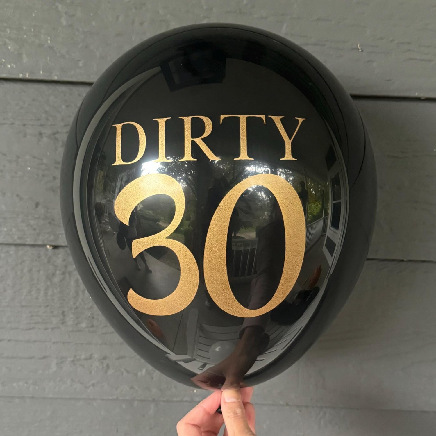 12 inch black latex balloon that reads Dirty 30 in a gold metallic font.
30th birthday balloons