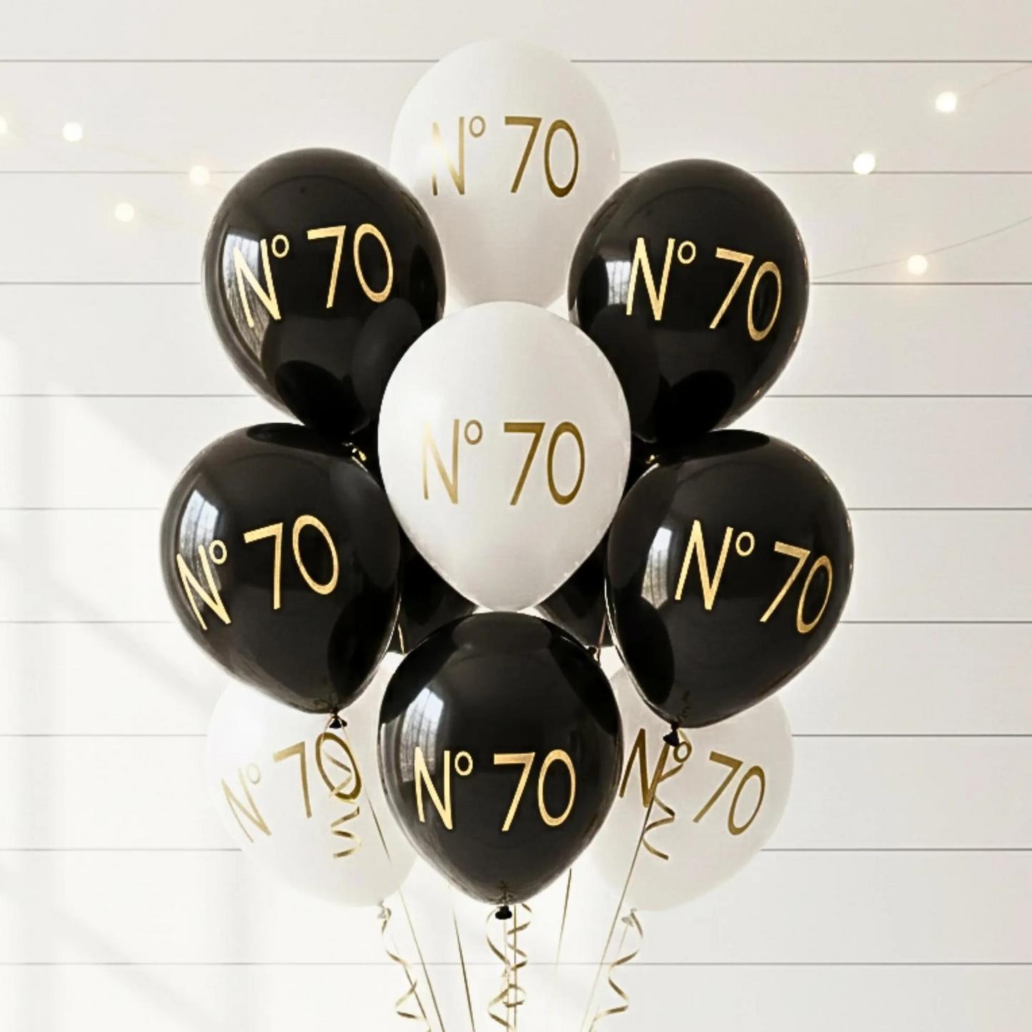 70th Birthday balloon.  A black and white balloon bouquet.  The balloons read no 70 in gold text.