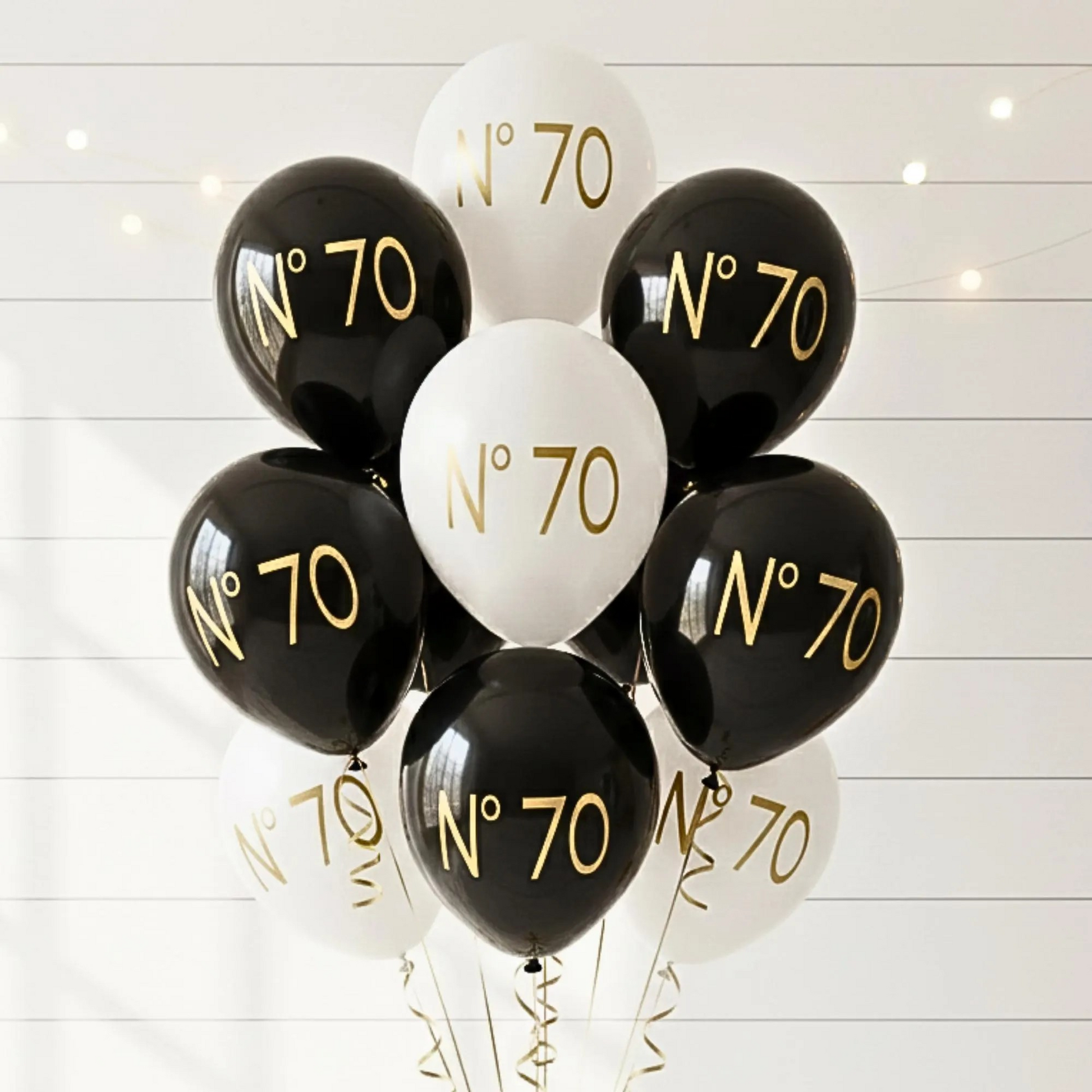 70th Birthday balloon.  A black and white balloon bouquet.  The balloons read no 70 in gold text.