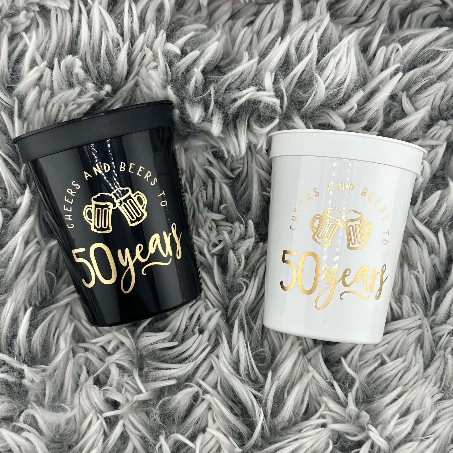 Cheers and Beers to 50 Years cups black and white with gold text