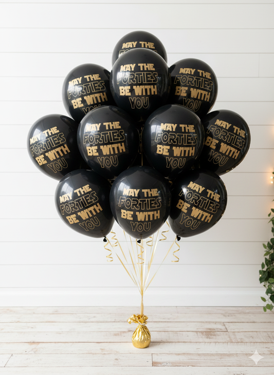 Black balloons with gold text 'May the Forties be with you' on a white background