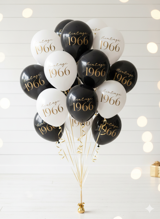 Bouquet of balloons with 'Vintage 1966' text on a white background with string lights.