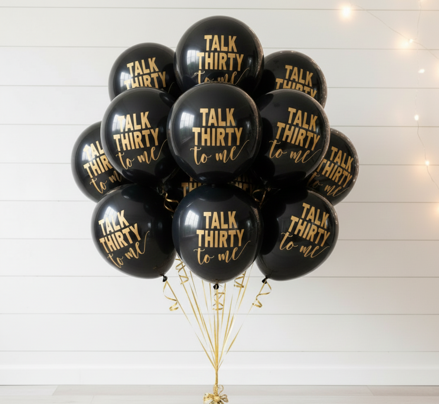 Black balloons with 'Talk Thirty to Me' text on a white background
