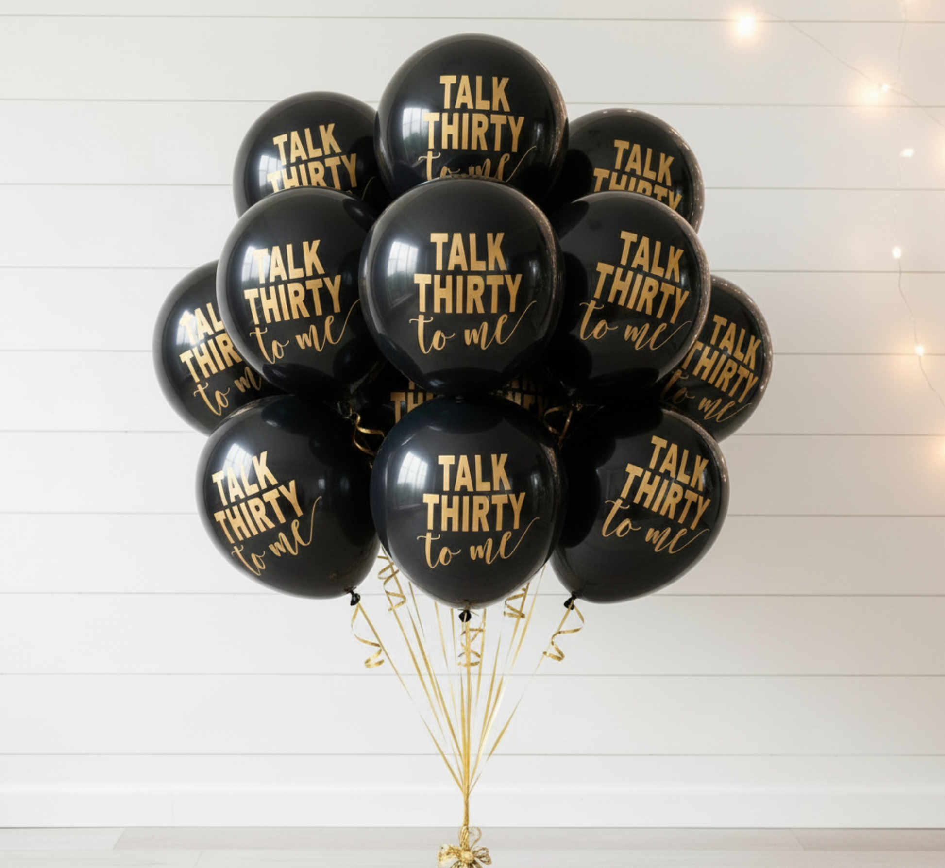 Black balloons with 'Talk Thirty to Me' text on a white background