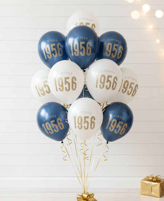 Balloons with '1956' printed on them against a white wooden background.