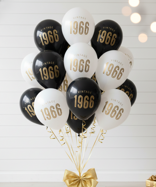 Decorative balloons with '1966' text tied together with a gold ribbon on a white background.