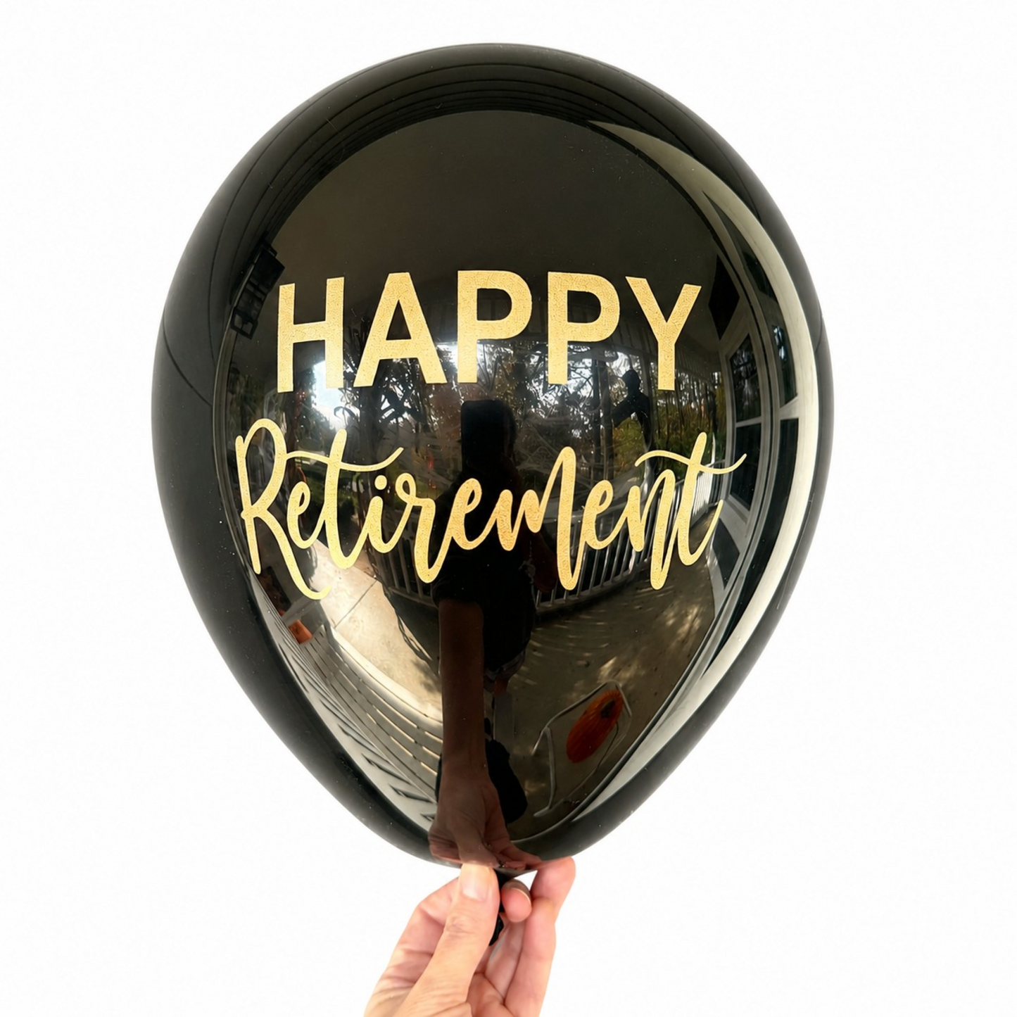 Retirement Party Balloons.  A black latex balloon with gold font that reads Happy Retirement.  Perfect retirement party decor.