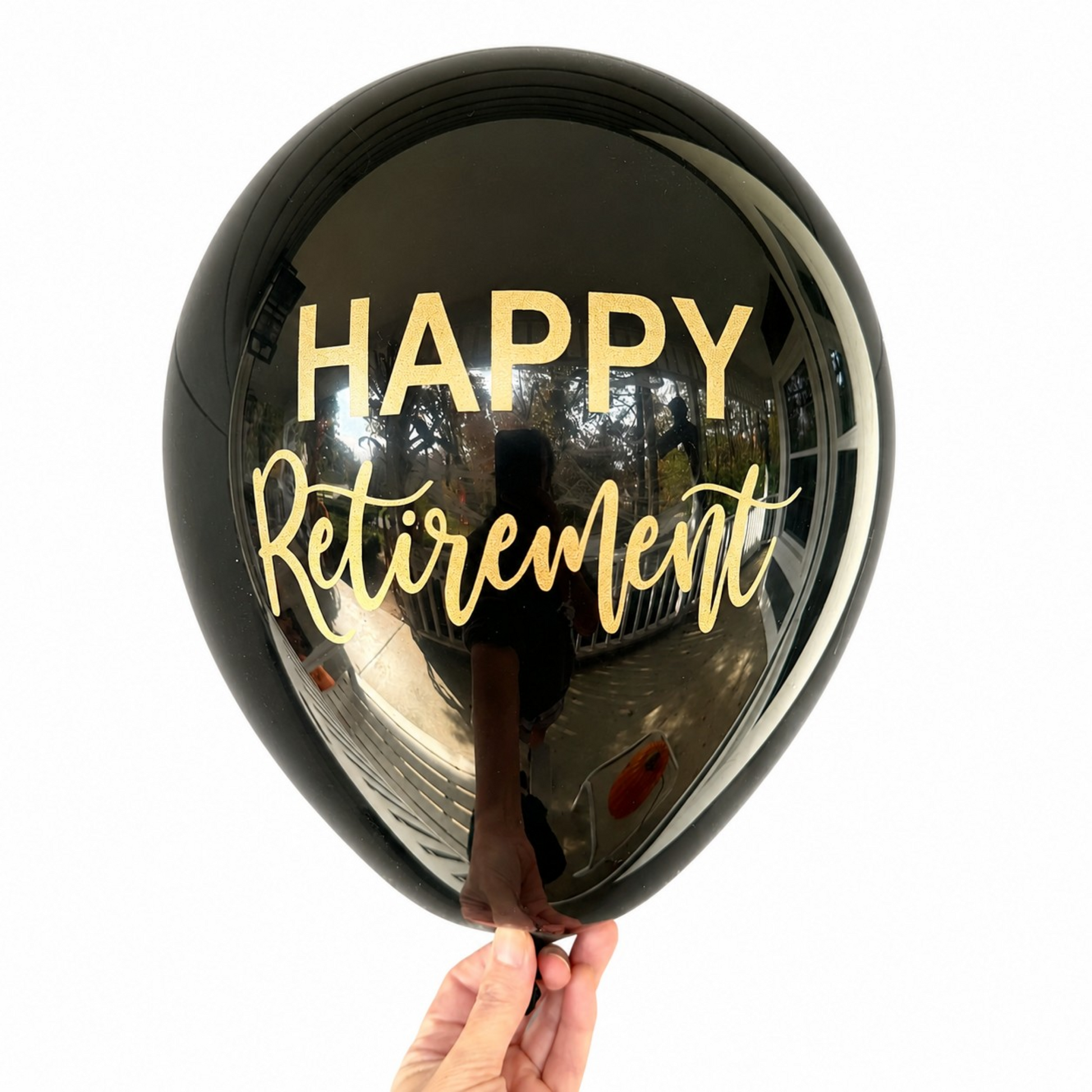 Retirement Party Balloons.  A black latex balloon with gold font that reads Happy Retirement.  Perfect retirement party decor.