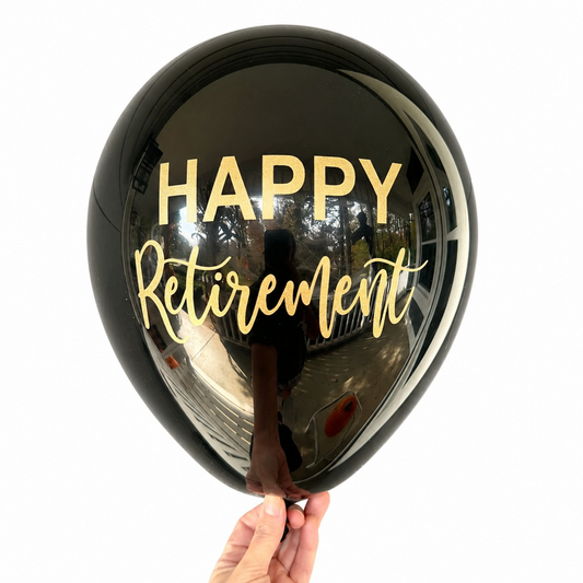 Retirement Party Balloons.  A black latex balloon with gold font that reads Happy Retirement.  Perfect retirement party decor.