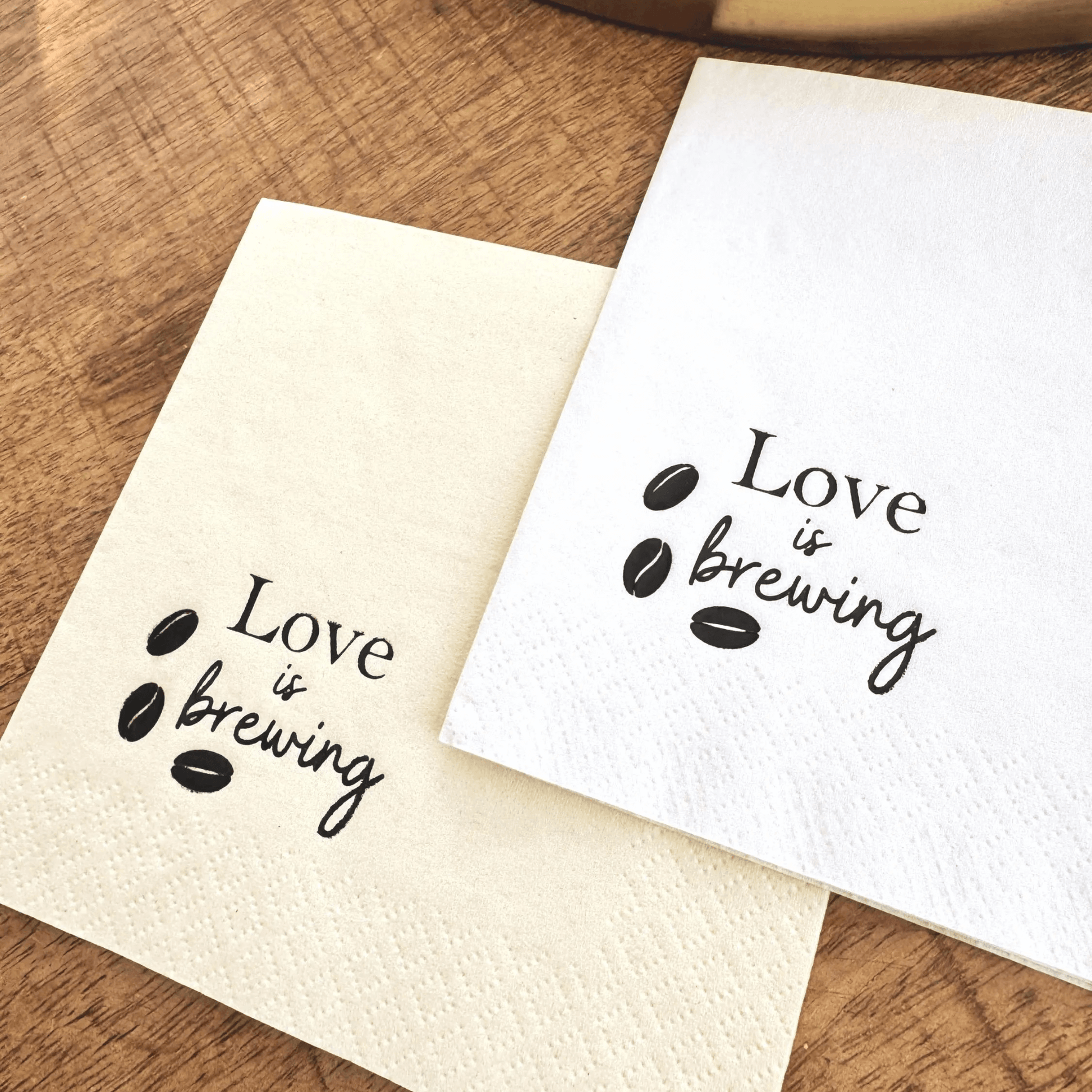 Love is brewing cocktail napkins stamped in a black foil with coffee beans