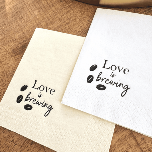 Love is brewing cocktail napkins stamped in a black foil with coffee beans