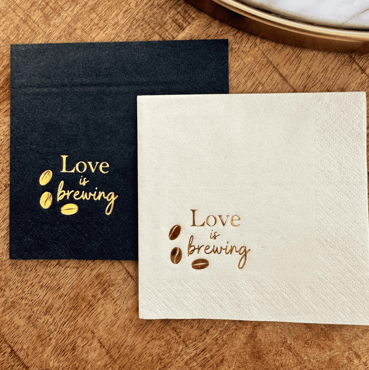 Love is brewing cocktail napkins stamped in a gold foil with coffee beans