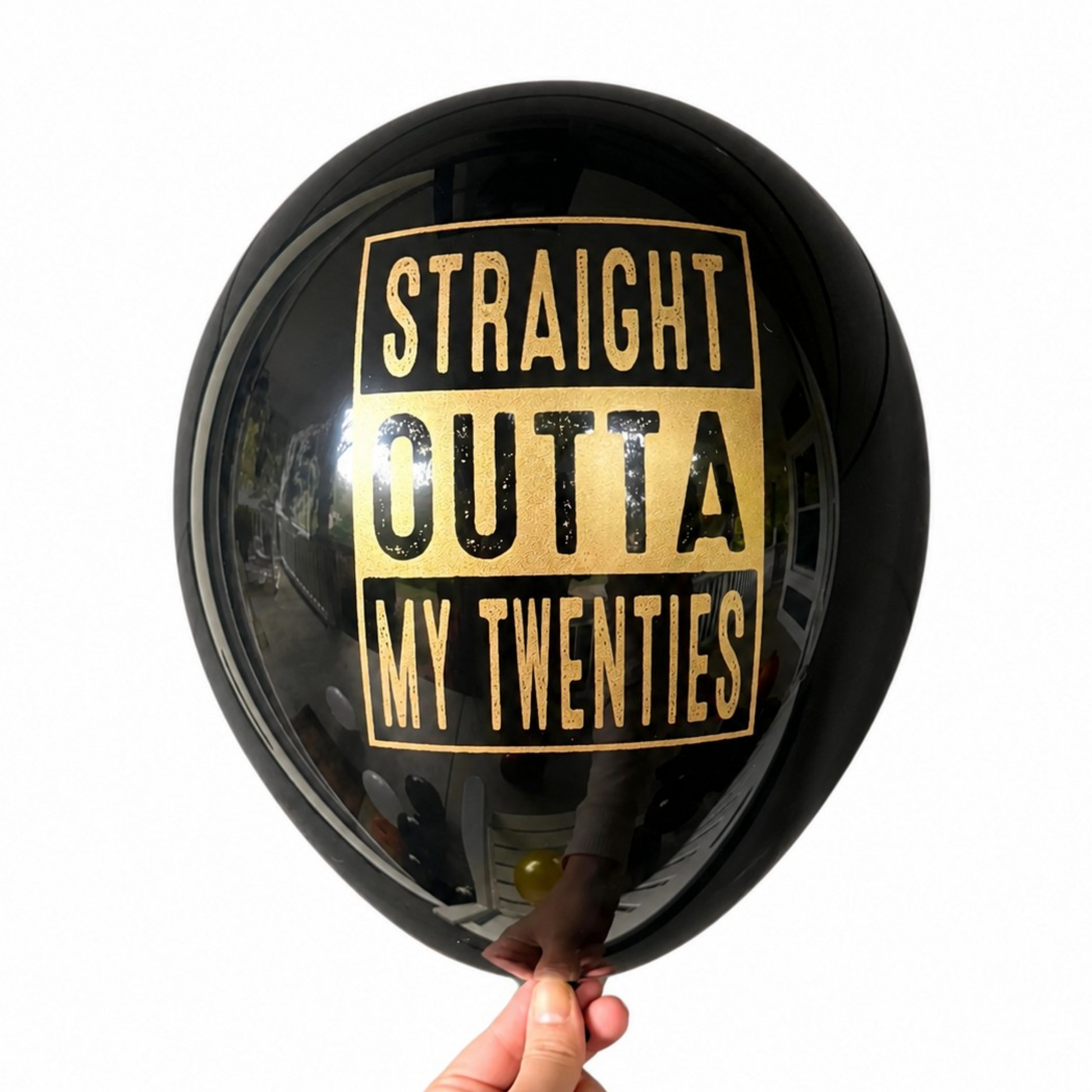 30th Birthday Balloon.  The balloon is black with gold text and reads Straight Outta My Twenties.  30th Birthday decor