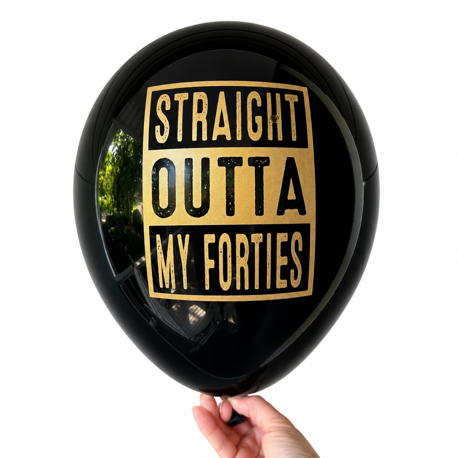 50th Birthday Balloons.  A black latex balloon with a gold foil graphic that reads 'STRAIGHT OUTTA MY FORTIES' in a distressed typewriter font.  These make perfect 50th Birthday Decorations for the milestone celebration