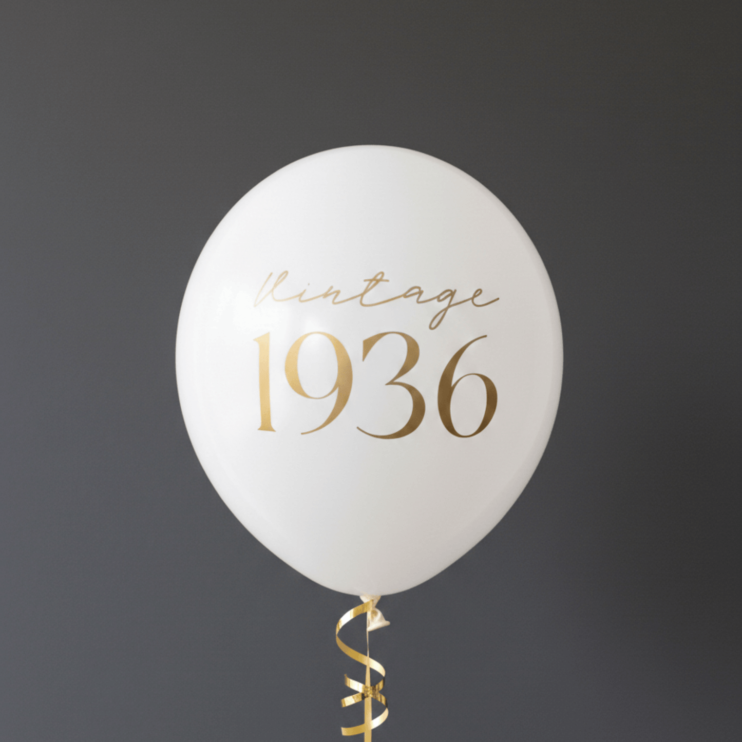 90th Birthday Balloons white with gold lettering that read Vintage 1936