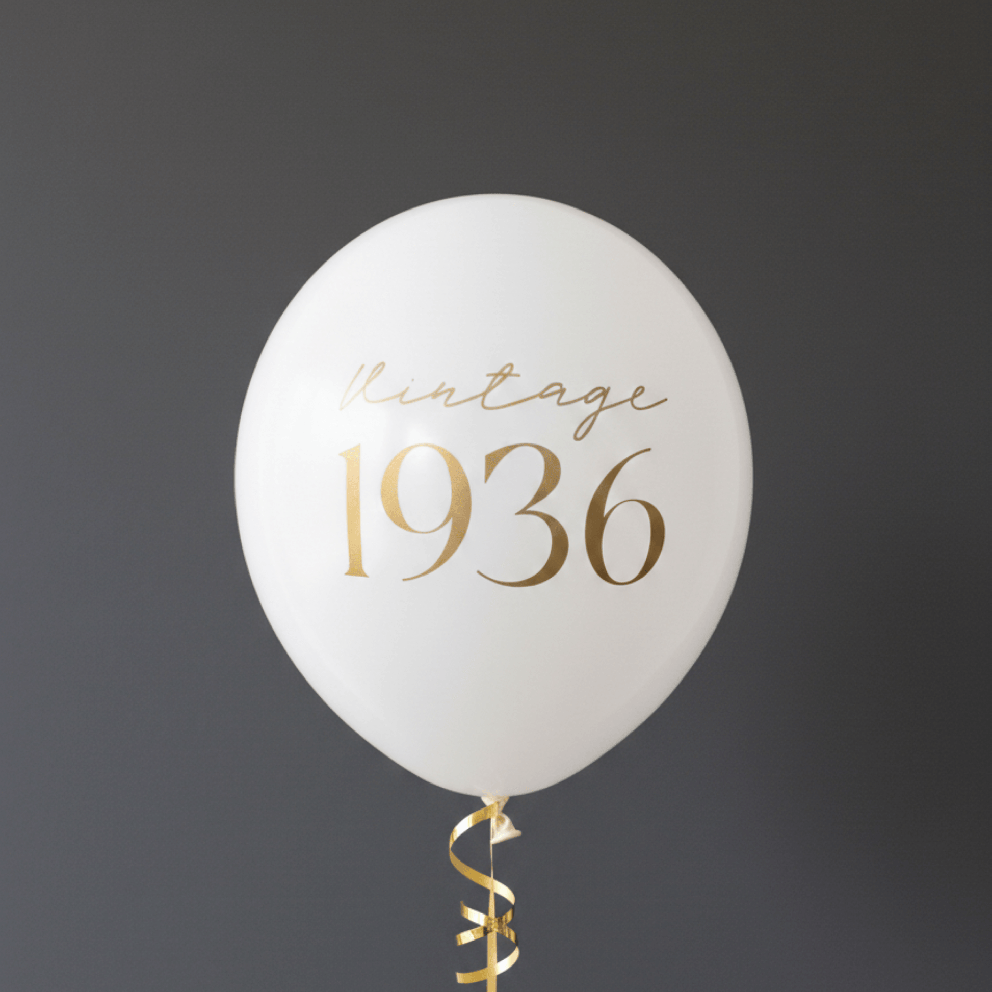 90th Birthday Balloons white with gold lettering that read Vintage 1936