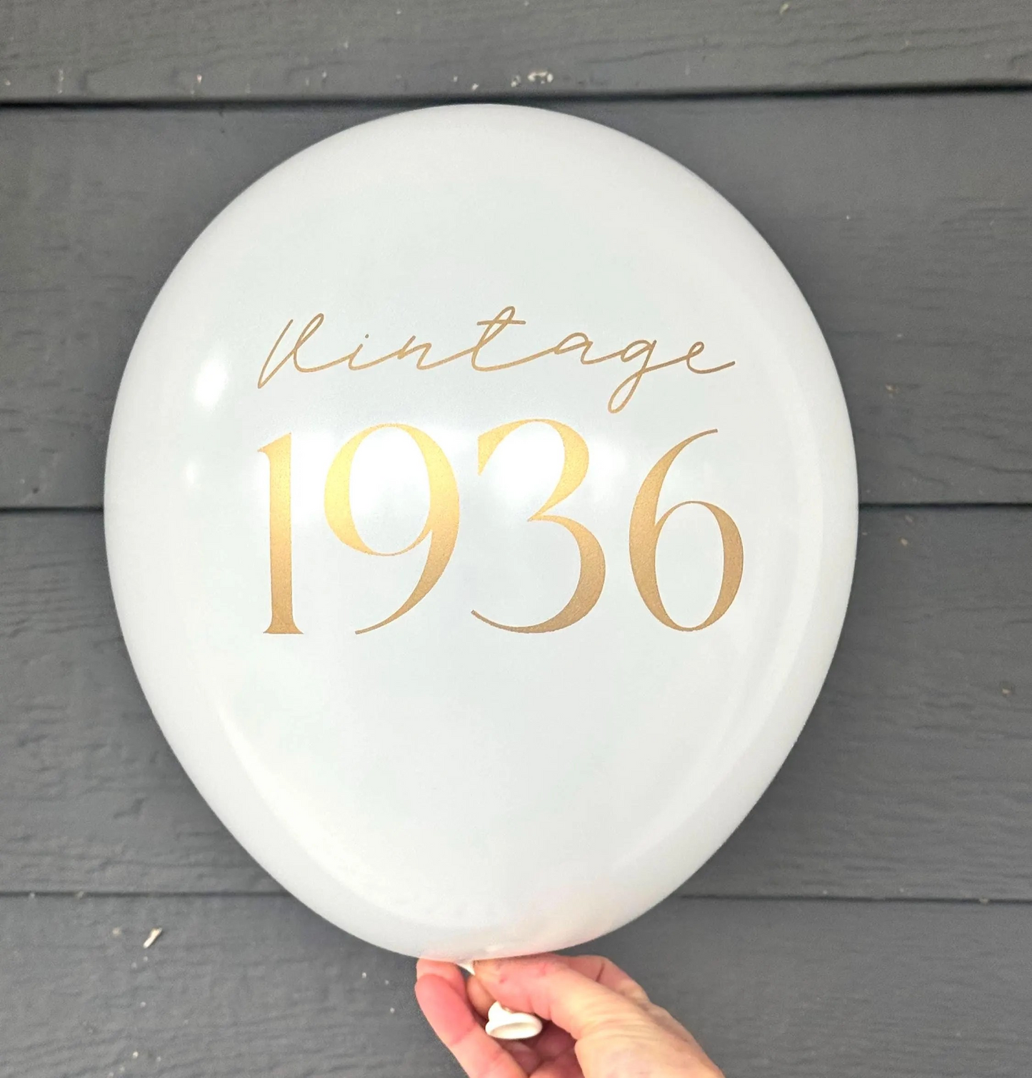 white latex balloon that reads Vintage 1936 in a gold font for a 90th Birthday.  90th Party Decorations