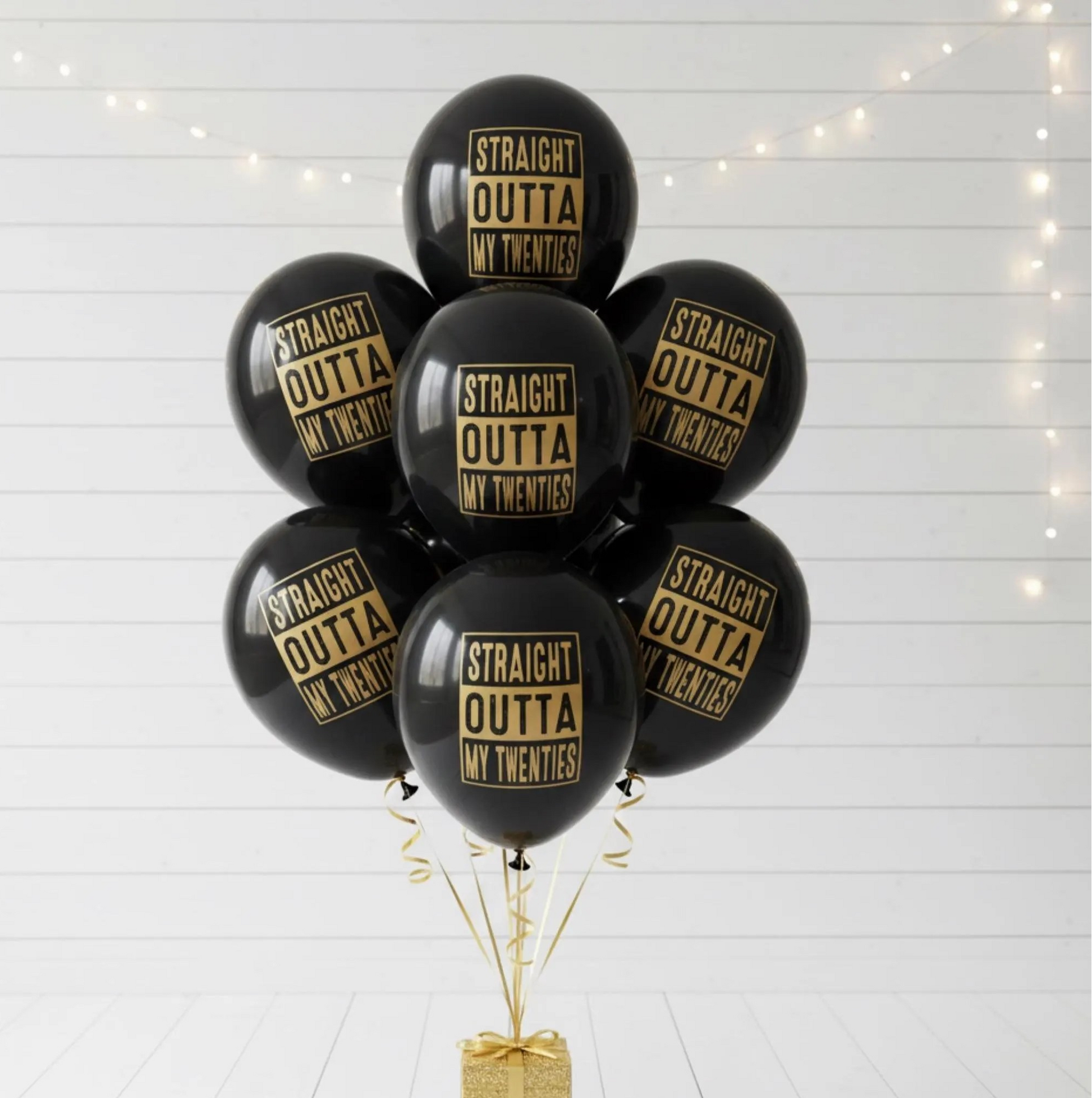 A Balloon bouquet of black balloons that read Straight outta my twenties in gold text.  30th Birthday Party Decorations