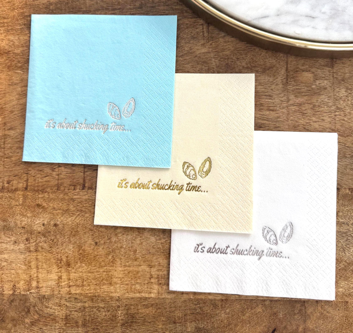 Foil Stamped Cocktail Napkins that read It's about shucking time with oyster shells.  Nautical Wedding Table Decorations