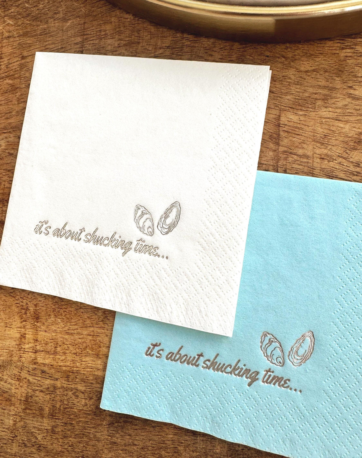 Foil Stamped Cocktail Napkins that read It's about shucking time with oyster shells.  Destination Wedding Napkins