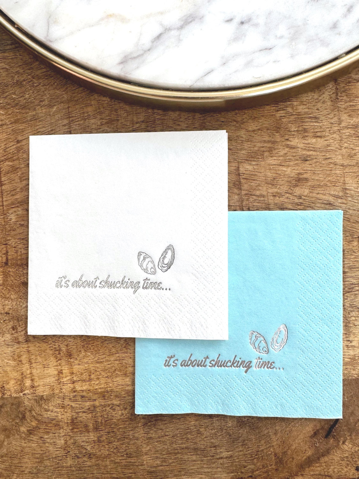 Foil Stamped Cocktail Napkins that read It's about shucking time with oyster shells.  Nautical Bridal shower Decor