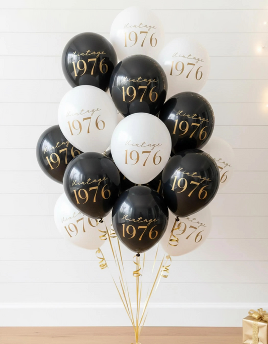 Black and white balloons with 'Vintage 1976' text on a white background