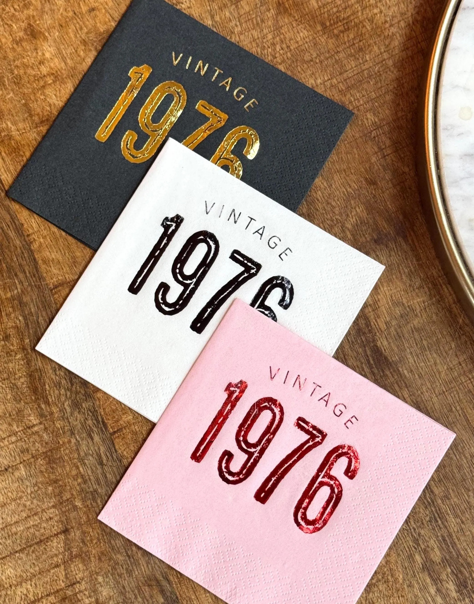 Cocktail napkins that read Vintage 1976 in a bold font stamped in different color foils.  50th Birthday Napkins