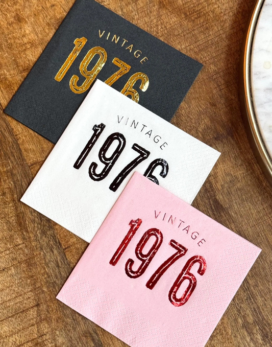 Cocktail napkins that read Vintage 1976 in a bold font stamped in different color foils.  50th Birthday Napkins