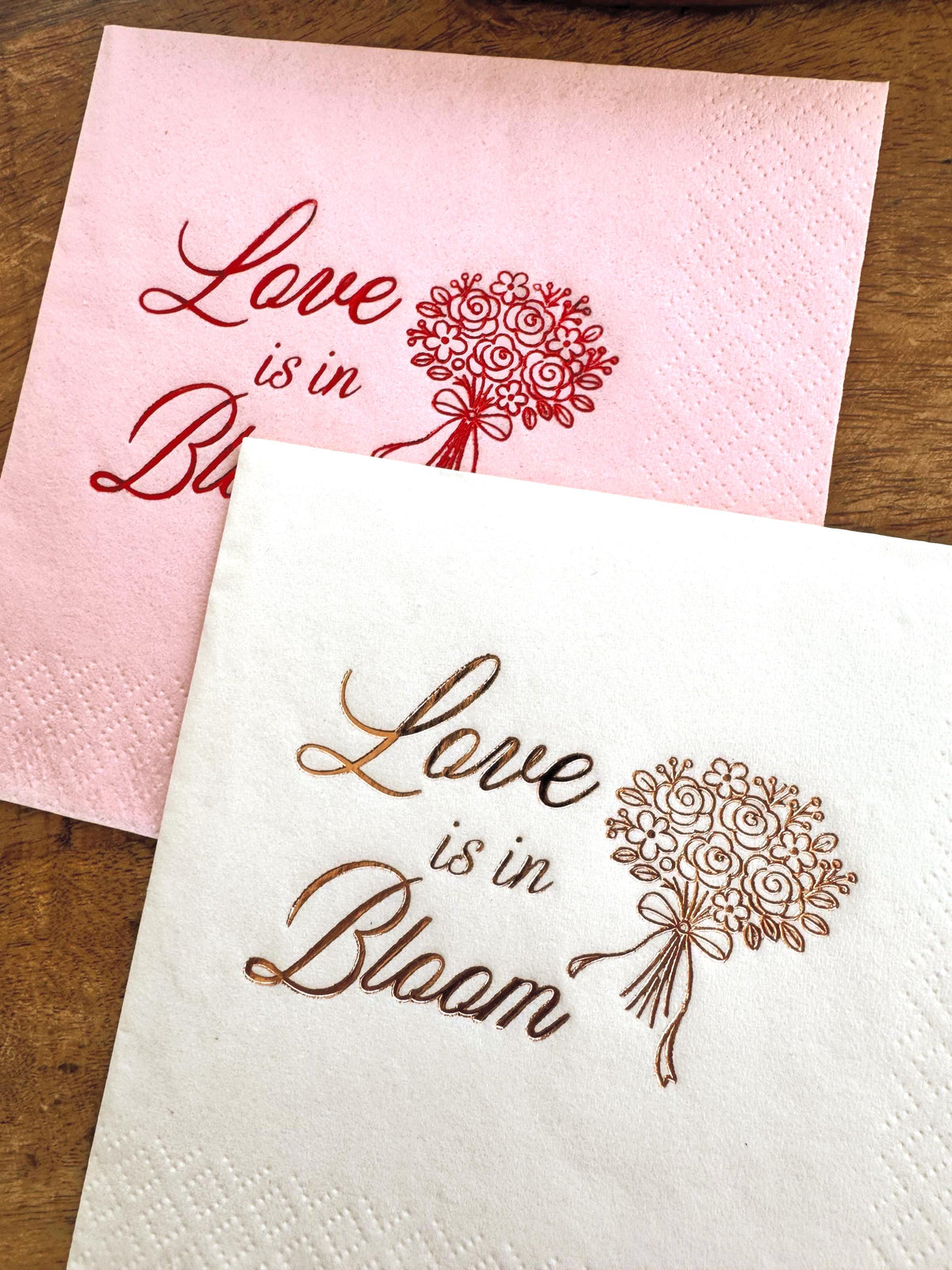 Floral party napkins reading “Love Is in Bloom” for baby shower, wedding, or spring celebration.  Foil Stamped Cocktail Napkins