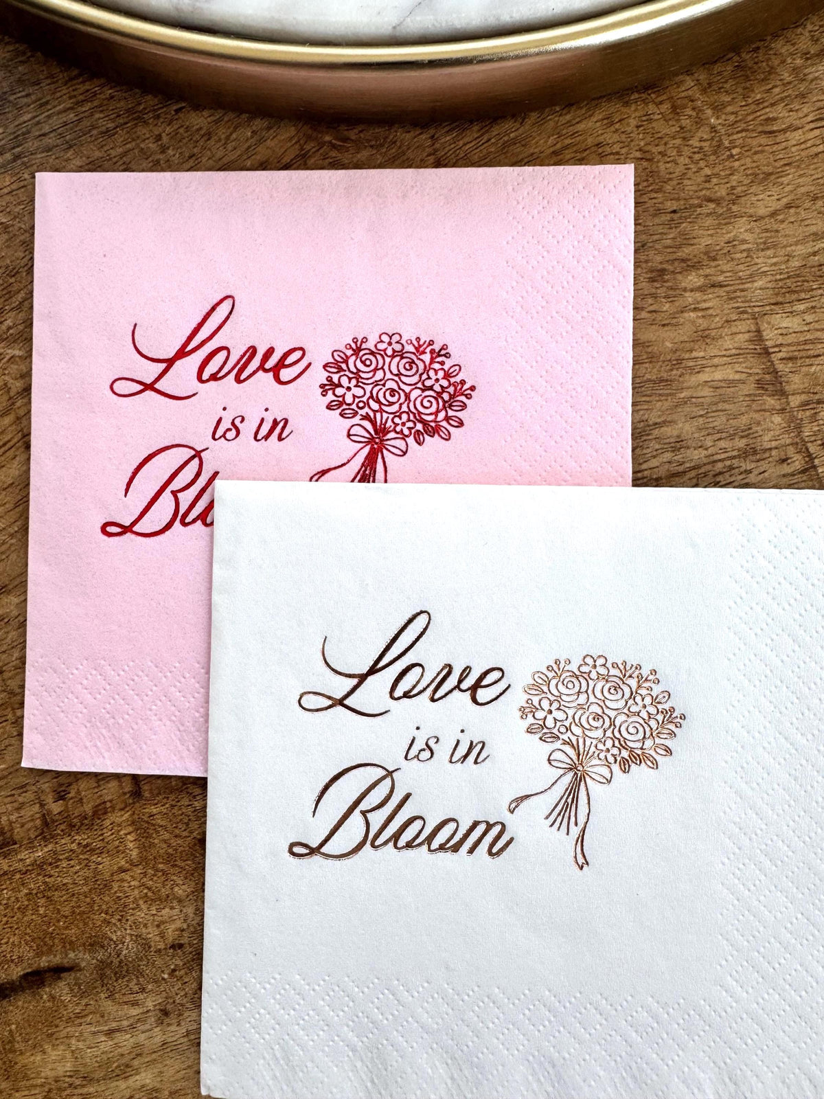 Paper cocktail napkins featuring “Love Is in Bloom” text with floral bouquet illustration.  Bridal Shower cocktail Napkin