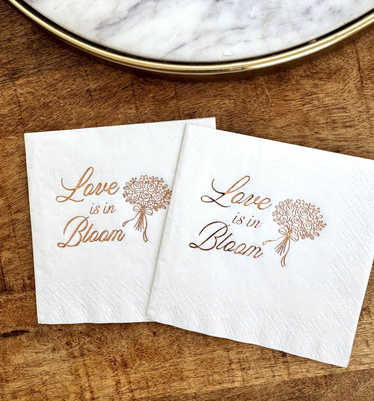 Floral party napkins reading “Love Is in Bloom” for baby shower, wedding, or spring celebration