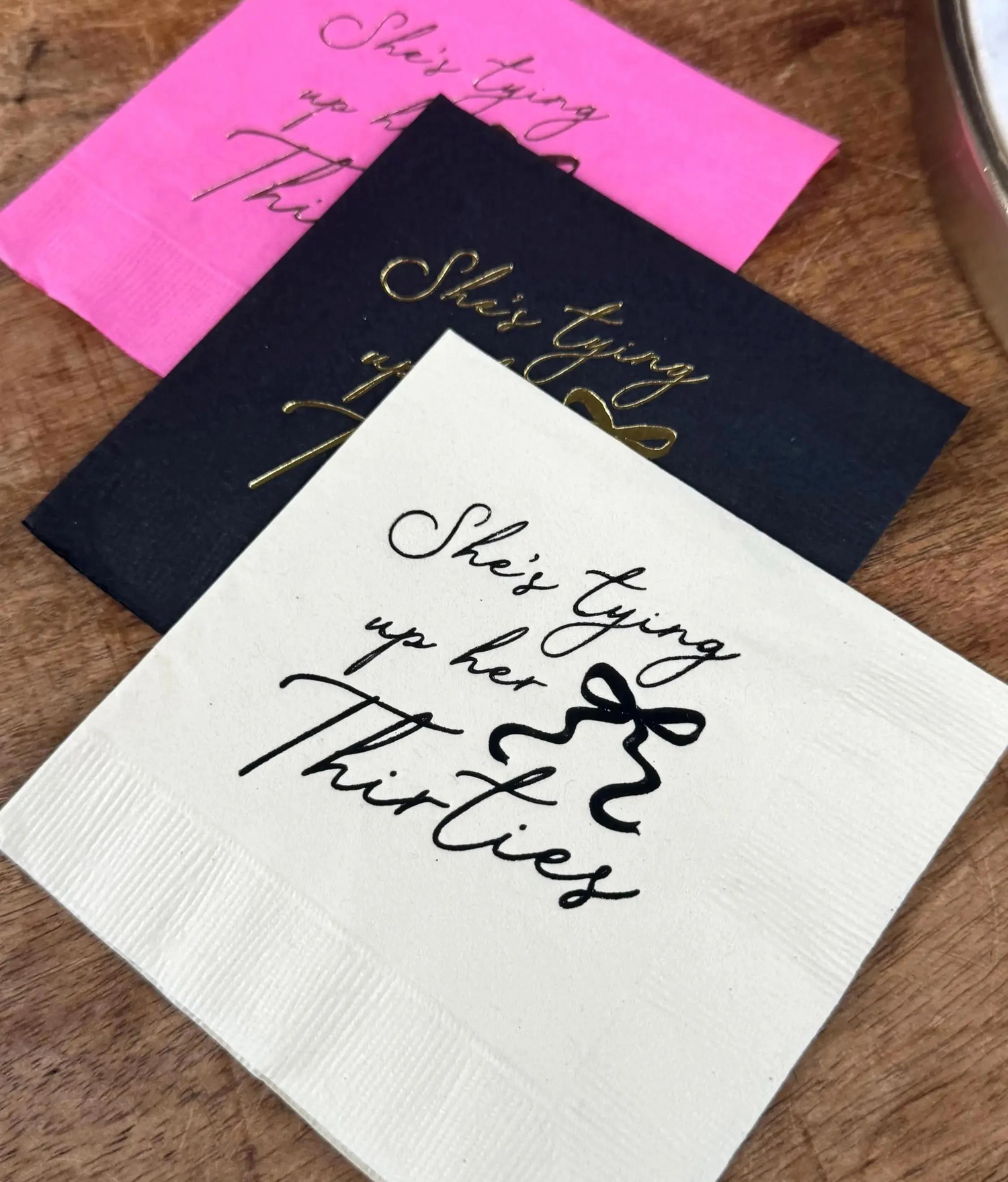 black, white, and magenta cocktail napkins that read She's tying up her Thirties with a coquette bow.
40th birthday napkins