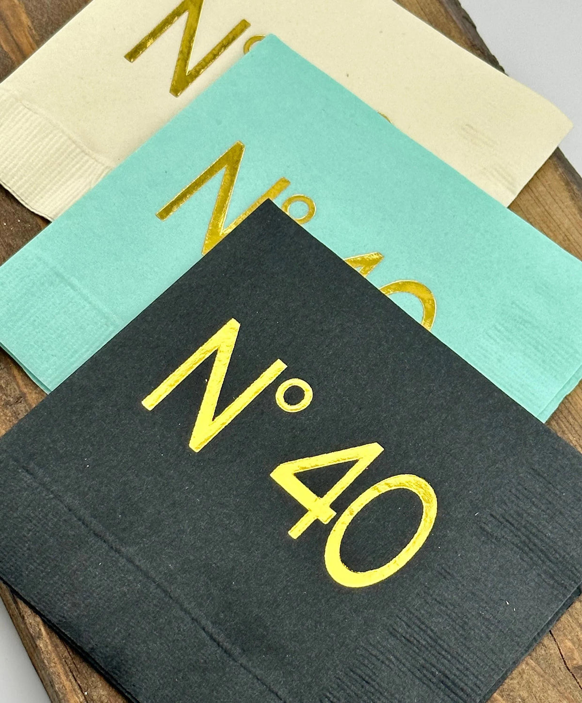 Coordinating No 40 paper napkins in black, mint green and cream with gold lettering.