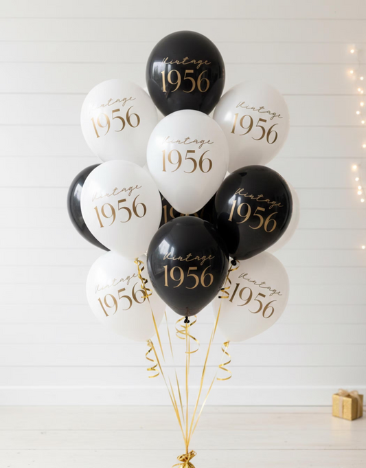 Black and white balloons with 'Vintage 1956' text on a light background