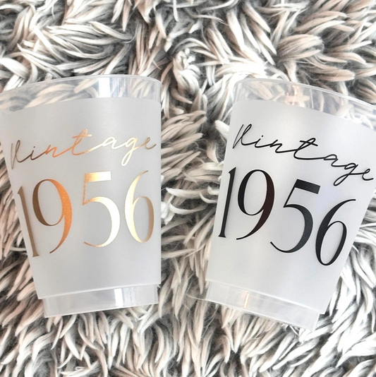 Two vintage 1956 themed frosted flex 16 ounce cups with 'Vintage 1956' text on a textured surface.