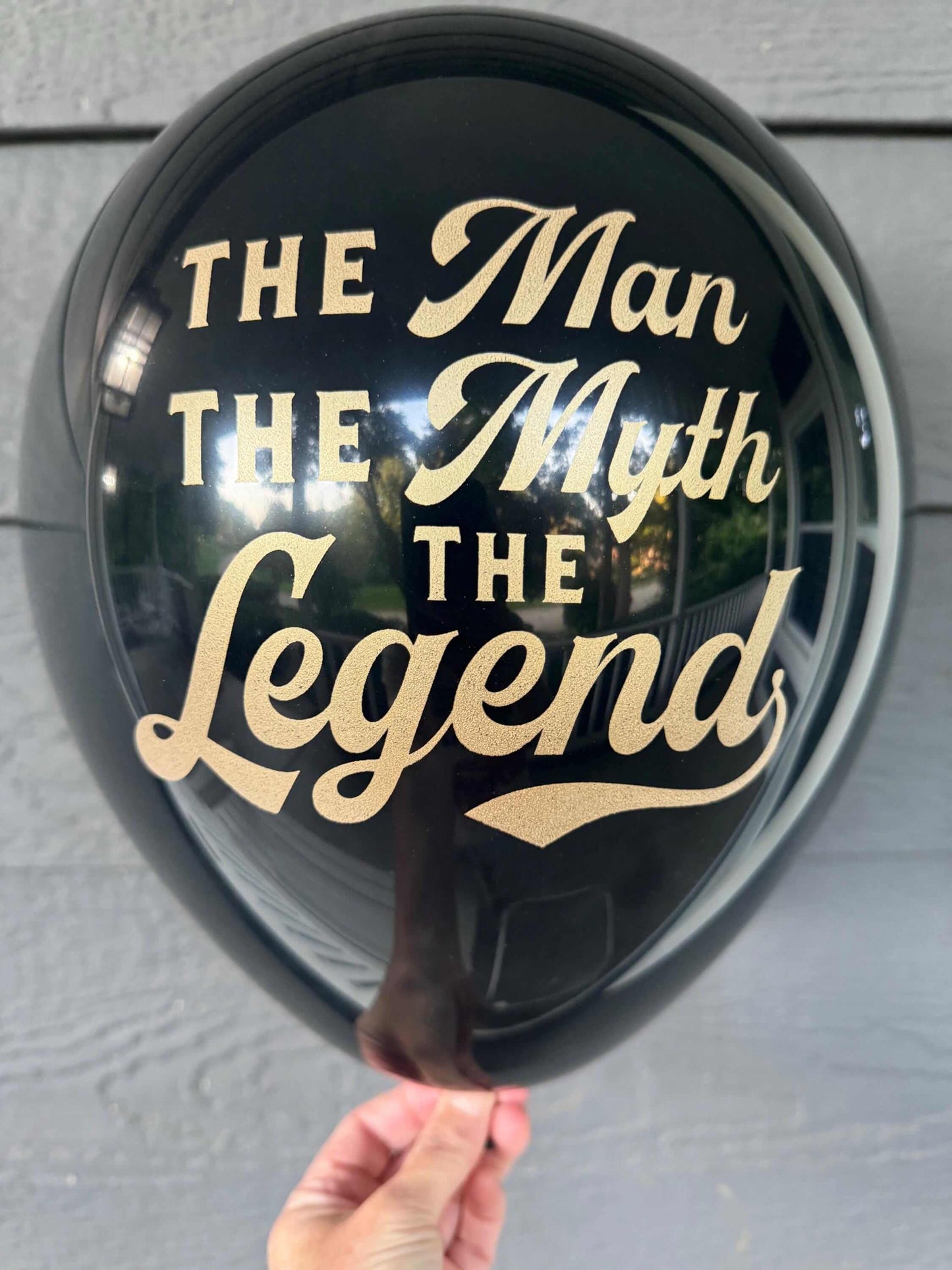 The Man The Myth The Legend balloons black and gold.  For a male birthday, retirement or milestone balloon decoration.