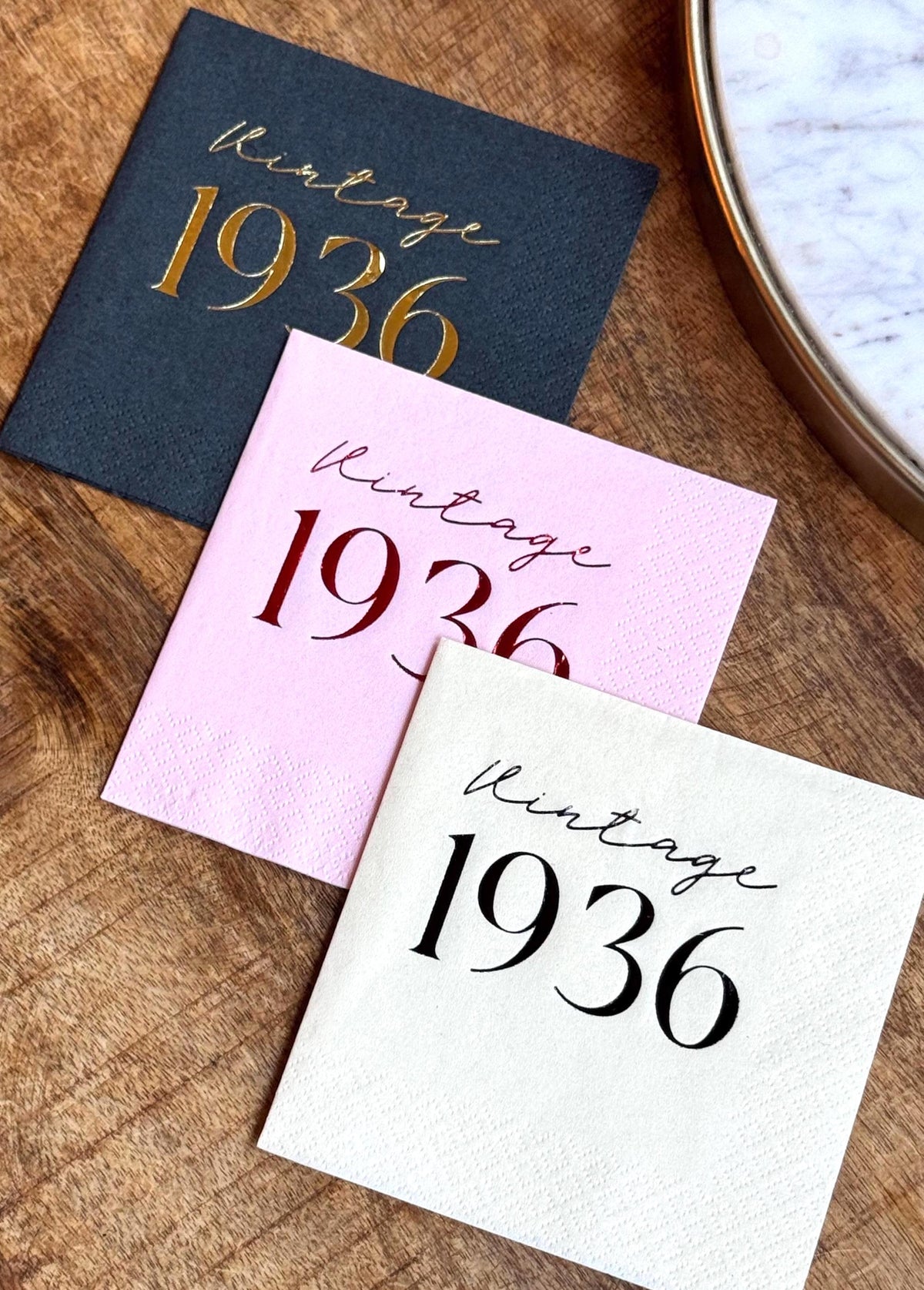 Foil stamped cocktail napkins reading “Vintage 1936” for milestone birthday celebration.