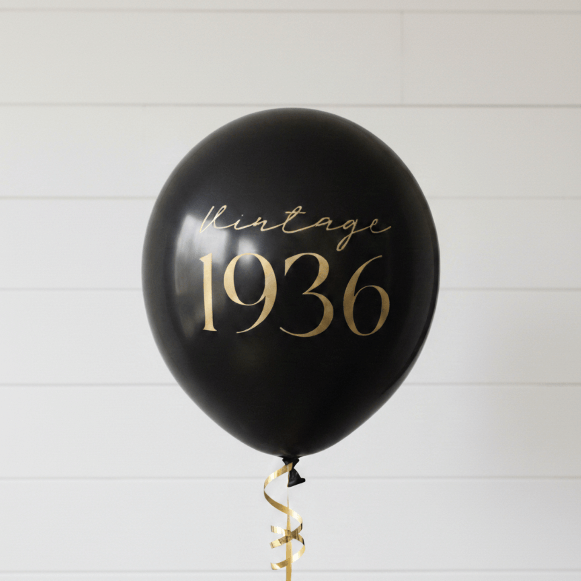 90th Birthday Balloons black with gold text that read Vintage 1936