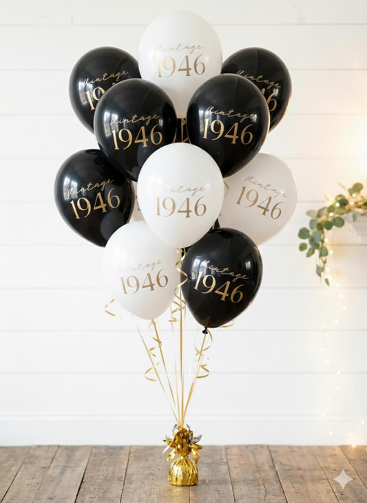 Black and white balloons with '1946' text on a wooden surface.